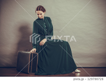 Woman retro style with old suitcase Woman retro style with old suitcase 129780728