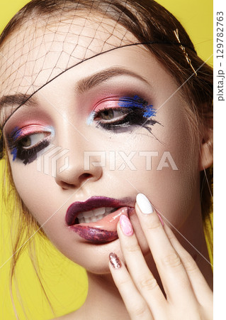 Dramatic Fashion Look young Woman. Beautiful Model with bright Make-up. Makeup style for Halloween Dramatic Fashion Look young Woman. Beautiful Model with bright Make-up. Makeup style for Halloween 129782763