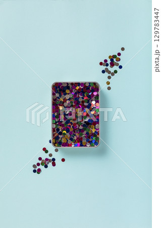 minimalist pastel blue background with confetti 129783447