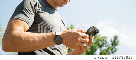 Man Hands Holding Smartphone in Outdoor Man Hands Holding Smartphone in Outdoor 129785813