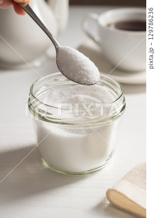 Spoon of sweetener in a jar. Sugar alternative, food and nutrition 129786236