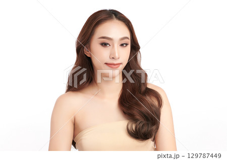 A beautiful young Asian woman with clean, fresh skin against a white background. Skincare, facial treatment, cosmetology, beauty, and spa. An elegant portrait of an Asian woman. A beautiful young Asian woman with clean, fresh skin against a white background. Skincare, facial treatment, cosmetology, beauty, and spa. An elegant portrait of an Asian woman. 129787449