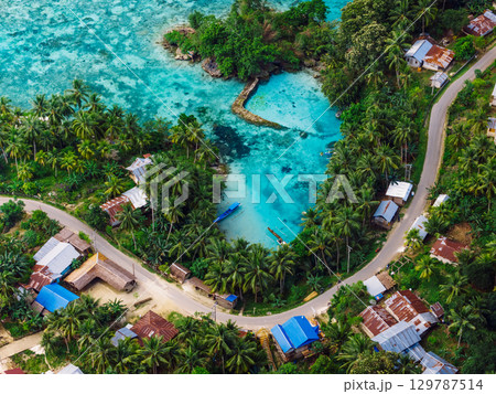 Sea coastline with lagoon and village with road in Indonesia. Aerial view Sea coastline with lagoon and village with road in Indonesia. Aerial view 129787514