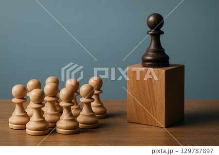 A black pawn on a wooden cube pawns below representing authoritative leadership recognition A black pawn on a wooden cube pawns below representing authoritative leadership recognition 129787897