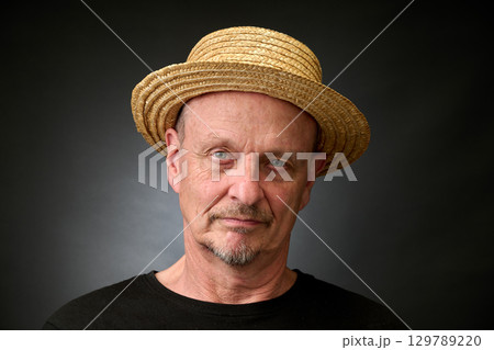 Portrait of a senior man in a vintage Harcourt style lighting 129789220