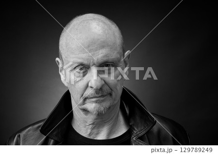 Monochrome Portrait of a senior man in a vintage Harcourt style lighting 129789249