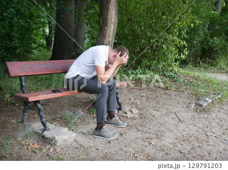 Sad guy on the park bench Sad guy on the park bench 129791203