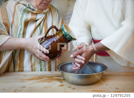 Woman pour water on hands Woman pour water on hands 129791205