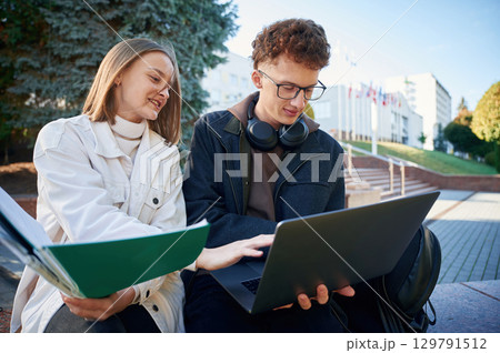 Two young students are together outdoors Two young students are together outdoors 129791512