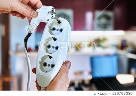 Homeowner plug too many heavy loads into light duty extension cord to burn down power cord tee. 129792050