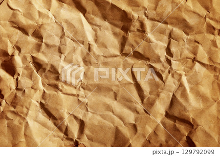Old grunge crumpled brown paper texture with dirty brown stain 129792099