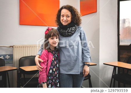 Female teacher with elementary student at language school class 129793559