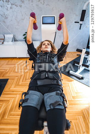 Empowered strength training session with muscle stimulation Empowered strength training session with muscle stimulation 129793617