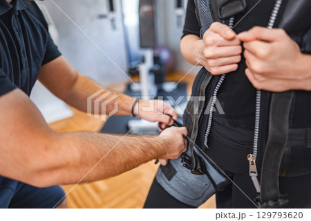 Electro muscle workout in a fitness studio Electro muscle workout in a fitness studio 129793620