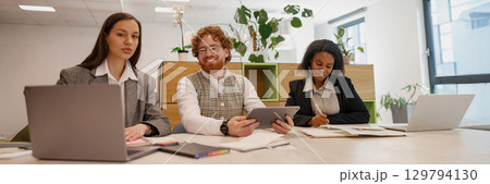 A Dedicated Focused Team Meeting Held in a Modern and Collaborative Office Space Environment A Dedicated Focused Team Meeting Held in a Modern and Collaborative Office Space Environment 129794130