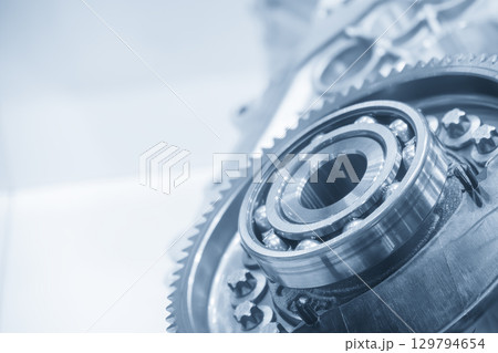 Close up assembly parts of ball bearing and gear part in the blue tone scene. 129794654