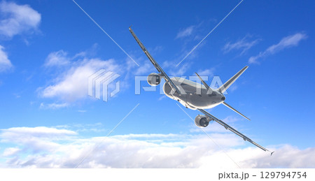 White passenger airplane flying in cloudy blue sky 129794754