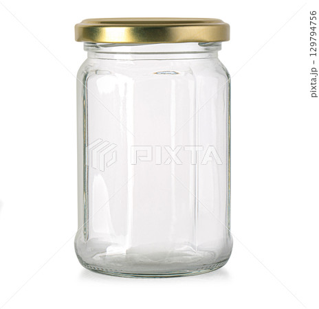Empty glass jar with golden lid standing on white background 129794756