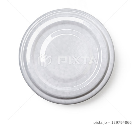 Grey metal lid from a jar resting on white background 129794866