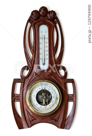 Antique wooden barometer and thermometer showing atmospheric pressure and temperature 129794900