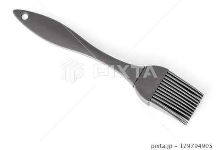 Gray silicone pastry brush resting on white background 129794905