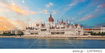 Hungarian parliament building reflecting on danube river at sunset in budapest 129794922
