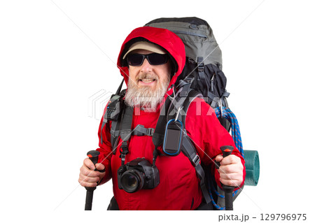 Experienced hiker prepares for adventure with heavy backpack in bright red jacket Experienced hiker prepares for adventure with heavy backpack in bright red jacket 129796975