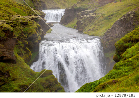 Exploring Seljalandsfoss waterfall in Iceland during a misty afternoon 129797193