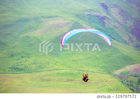 Spectacular paragliding adventure over the lush landscapes of Iceland's hills 129797572