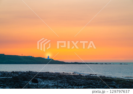 Sunset Over Fuguei Cape Lighthouse in Shimen, New Taipei City. 129797637