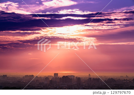 Vibrant Orange and Purple Sunset Sky Over Yilan, Taiwan. 129797670