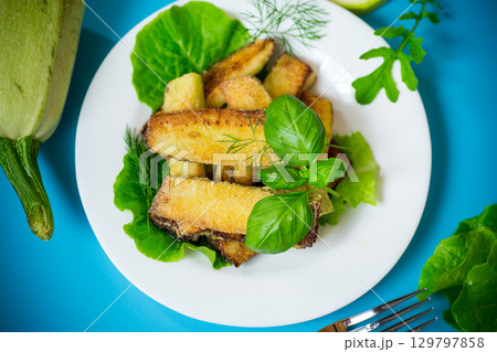 Vegetable appetizer of zucchini and dill on a blue background Vegetable appetizer of zucchini and dill on a blue background 129797858