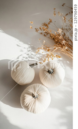 Craft a cozy autumn vibe with elegant white pumpkins and dried flowers 129798459