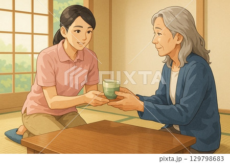 和室でお茶を渡す介護士 129798683