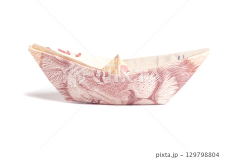 Money origami boat with South African money 50 rand isolated on white Money origami boat with South African money 50 rand isolated on white 129798804