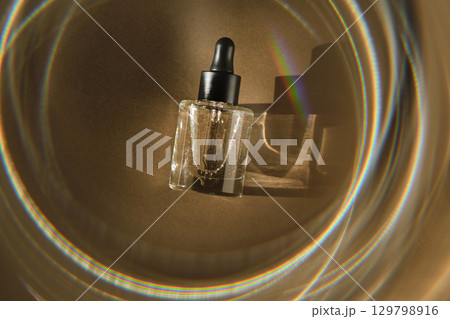 Natural facial oil with beautiful highlights on a beige background. Natural facial oil with beautiful highlights on a beige background. 129798916