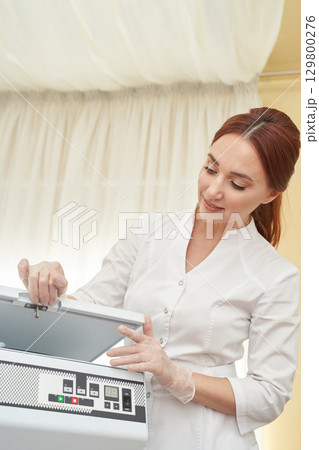 Female caucasian adult technician using laboratory equipment for scientific 129800276