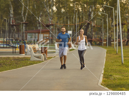 Couple jogging in the park having sport workout in nature together. Healthy lifestyle concept. Couple jogging in the park having sport workout in nature together. Healthy lifestyle concept. 129800485