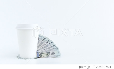 Coffee Cup with Money on White Background. Business Concept, Investment and Expenses. Coffee Cup with Money on White Background. Business Concept, Investment and Expenses. 129800604