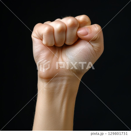 Woman hand making fist gesture on black background Woman hand making fist gesture on black background 129801731