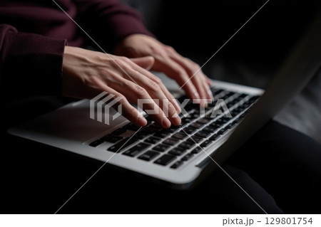 Programmer writing code on laptop keyboard in dark room Programmer writing code on laptop keyboard in dark room 129801754