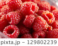 Fresh raspberries showing tiny hairs and seeds filling frame. Preparing for winter storage 129802239