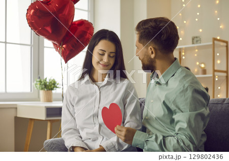 Young couple in love celebrating Valentine's Day and having a romantic date at home 129802436