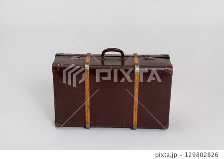 An exquisite Vintage Brown Suitcase adorned with Wooden Straps for stylish travel adventures 129802826