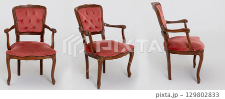 An Elegant Vintage Armchair featuring beautiful Pink Upholstery and Intricate Carvings 129802833