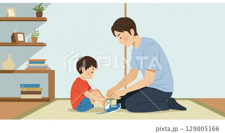 愛情いっぱい！子供の靴紐を結ぶ優しい父親 129805166