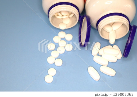 White Pills and Tablets on Blue White Pills and Tablets on Blue 129805365