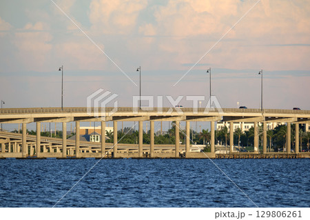 Barron Collier Bridge and Gilchrist Bridge in Florida with moving traffic. Transportation infrastructure in Charlotte County connecting Punta Gorda and Port Charlotte over Peace River Barron Collier Bridge and Gilchrist Bridge in Florida with moving traffic. Transportation infrastructure in Charlotte County connecting Punta Gorda and Port Charlotte over Peace River 129806261