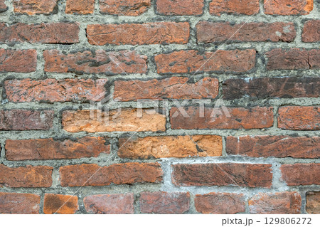 Weathered old red brick background with rough surface. 129806272