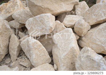 Big pile of large sand stones laying on the ground of construction site. Big pile of large sand stones laying on the ground of construction site. 129806273